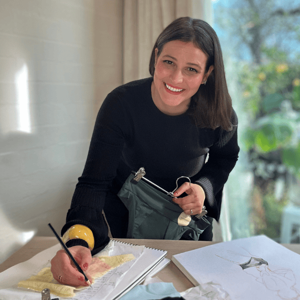 Wicks Intimates founder at her work desk smiling at the camera