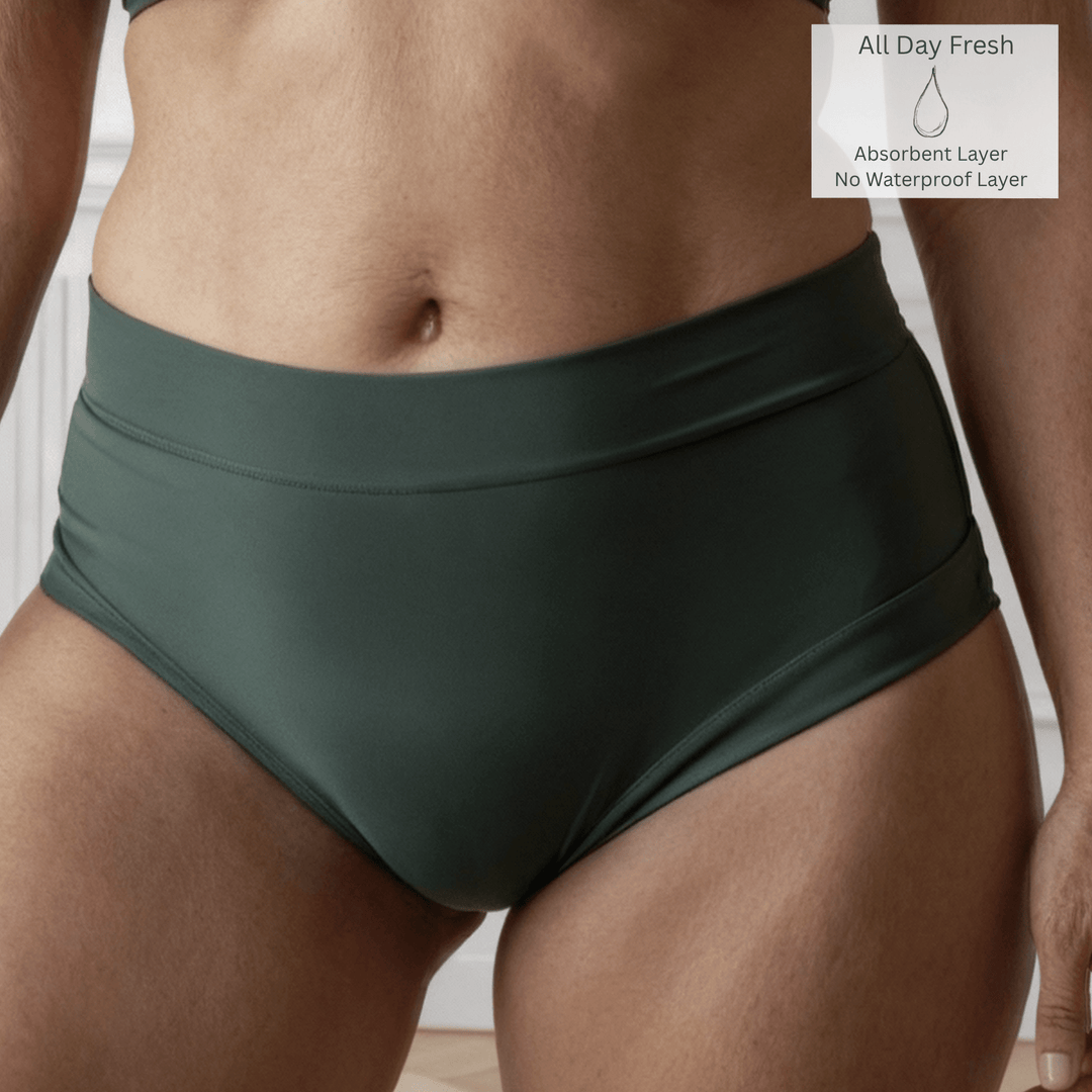 Detail of a woman wearing the Anything But Basic brief in Forest green from the Wicks Intimates All Day Fresh range and made from OEKO TEX certified fabric. A All Day Fresh icon is in the top right of the image to indicate there is one absorbent layer but no waterproof layer