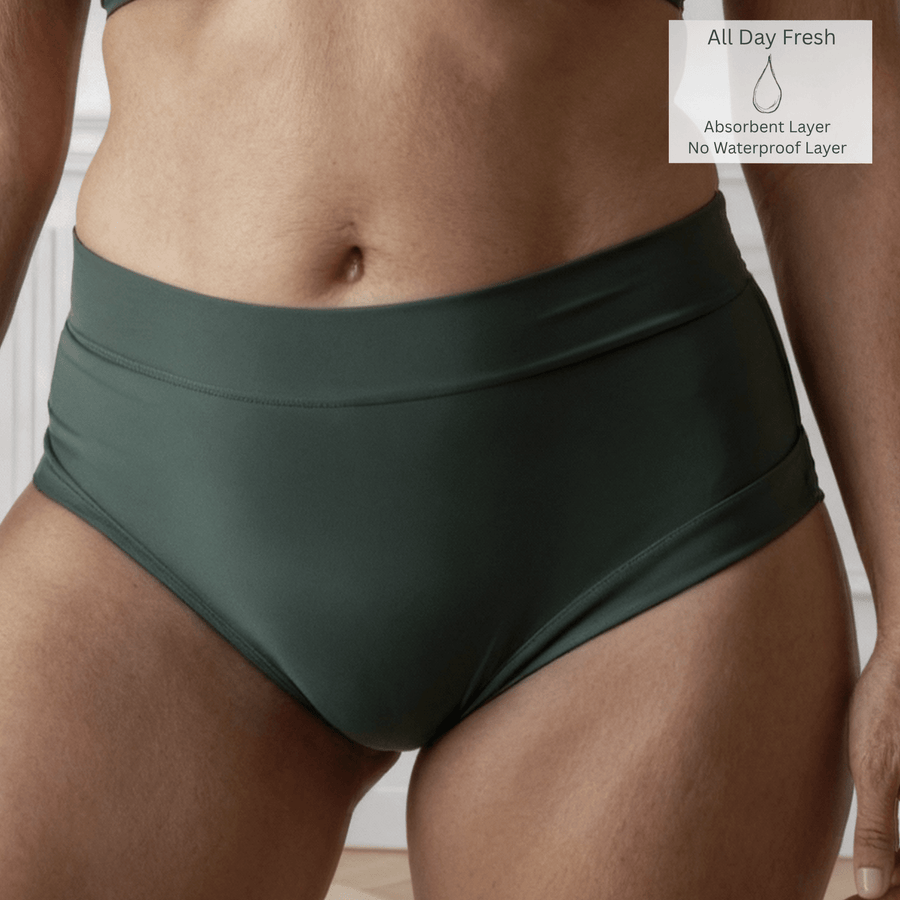 Detail of a woman wearing the Anything But Basic brief in Forest green from the Wicks Intimates All Day Fresh range and made from OEKO TEX certified fabric. A All Day Fresh icon is in the top right of the image to indicate there is one absorbent layer but no waterproof layer