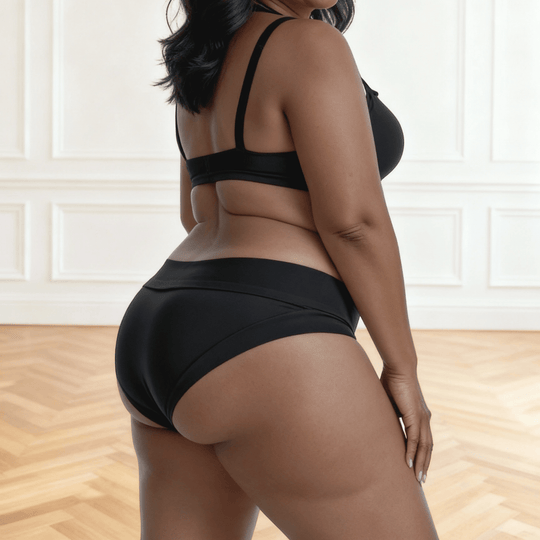 Detail of woman in her 30s facing to the side wearing a size Extra Large Elevated Essentials brief in Obsidian Black made from OEKO TEX certified fabric