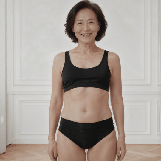 Detail of woman in her 60s facing forward wearing a size Medium Elevated Essentials brief in Obsidian Black made from OEKO TEX certified fabric