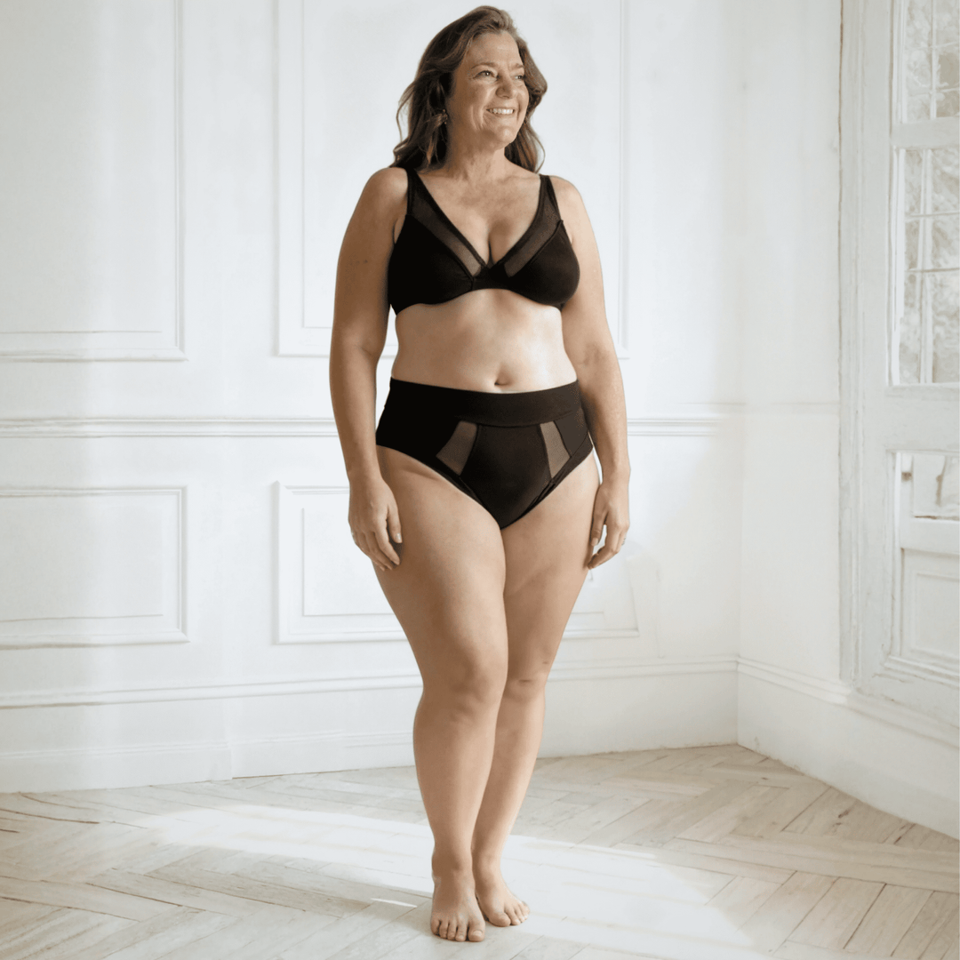 Woman in her 50s wearing the size 2XL high-waisted Emanate brief in Obsidian Black made from OEKO TEX certified fabric