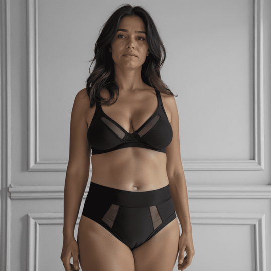 Woman in her 40s wearing the size Medium high-waisted Emanate brief in Obsidian black made from OEKO TEX certified fabric