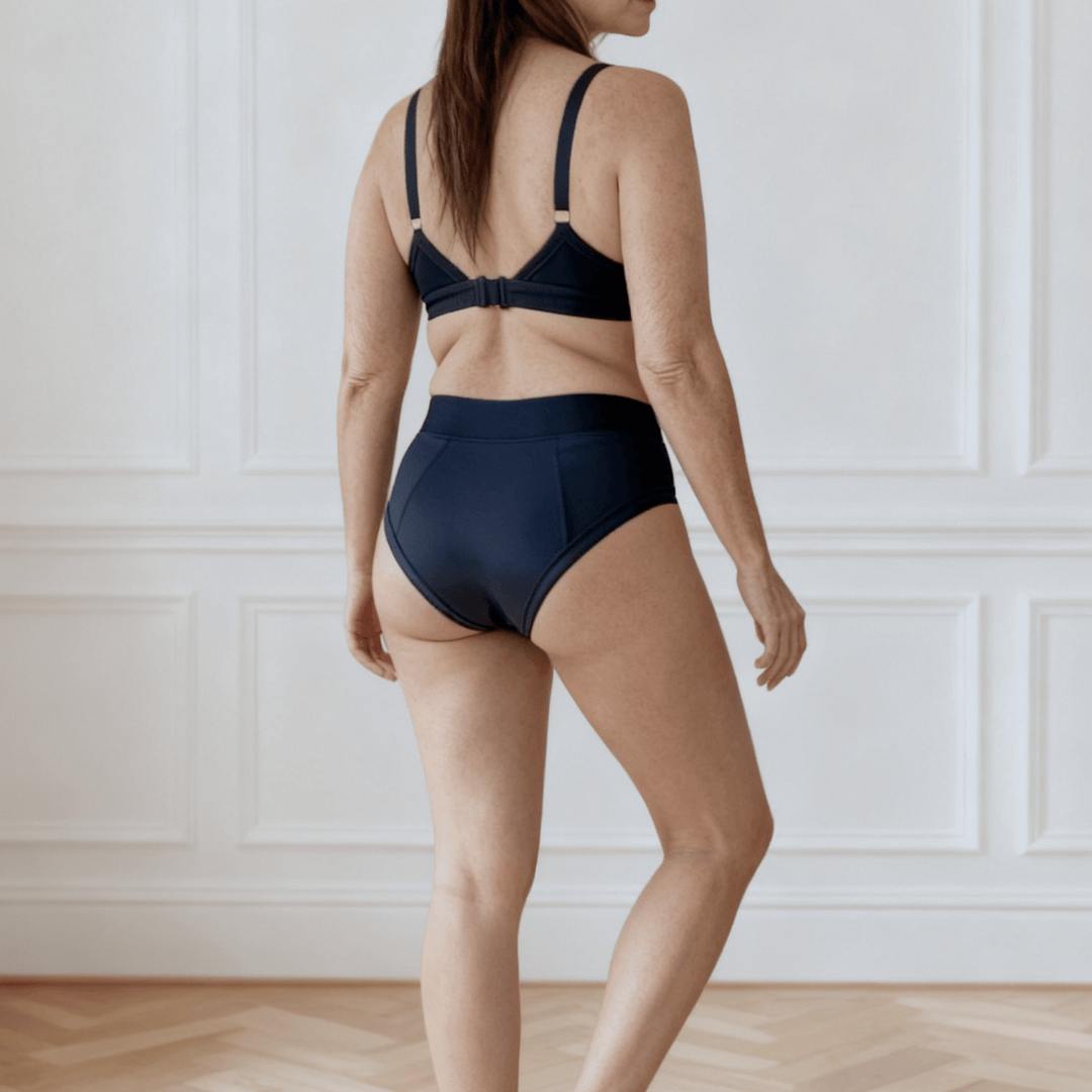 Detail of woman in her 30s facing away from the viewer wearing the Emanate brief in Slate Navy made from OEKO TEX certified fabric