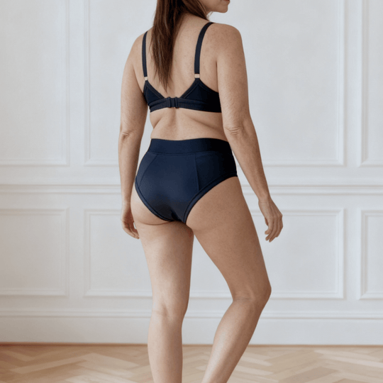 Detail of woman in her 30s facing away from the viewer wearing the Emanate brief in Slate Navy made from OEKO TEX certified fabric