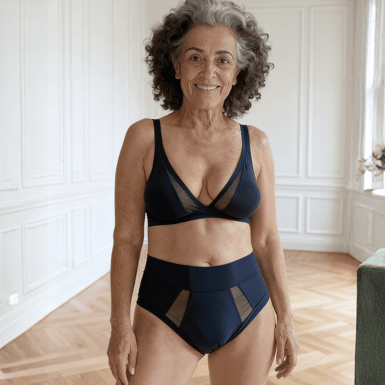 Woman in her 70s is facing the viewer wearing the size Medium Emanate brief in Slate Navy made from OEKO TEX certified fabric