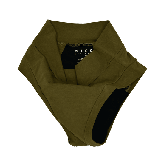 Artfully strewn flat lay image of the High Waisted basic brief in Moss green made from GOTS certified organic cotton