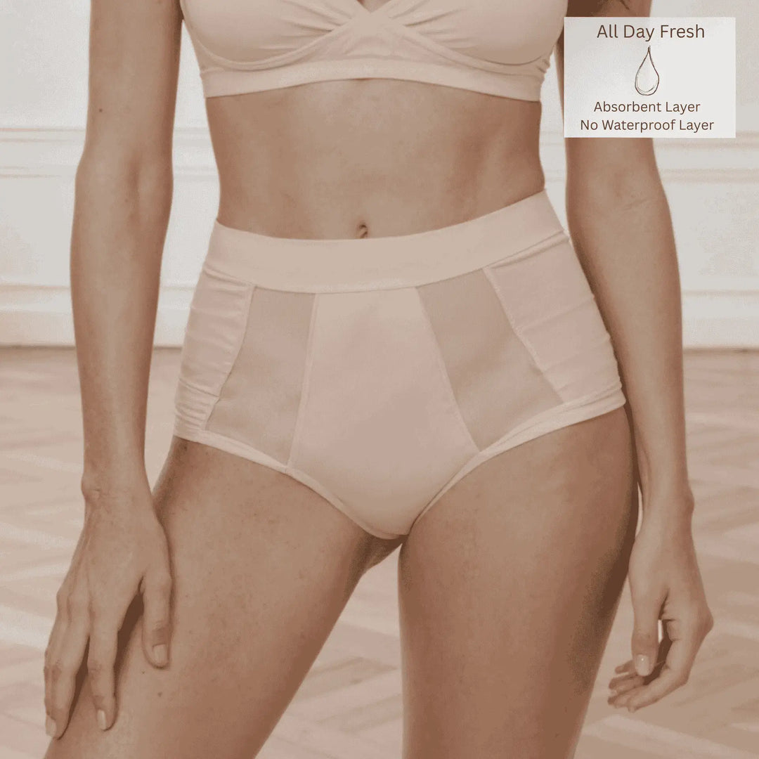 Front detail of woman wearing the Wicks Intimates Emanate Brief in Shell (nude) with absorbency badge showing they are from All Day Fresh Range.