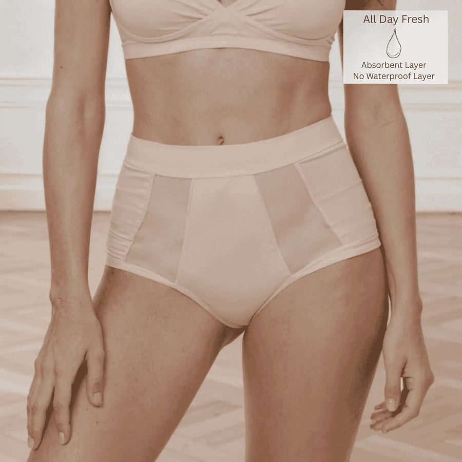 Front detail of woman wearing the Wicks Intimates Emanate Brief in Shell (nude) with absorbency badge showing they are from All Day Fresh Range.