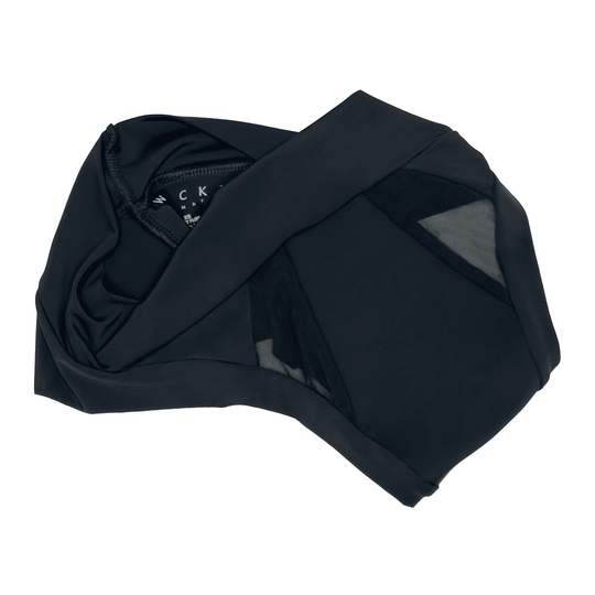 Artfully strewn flat lay image of the Striation Thong in Obsidian Black made from OEKO TEX certified fabric