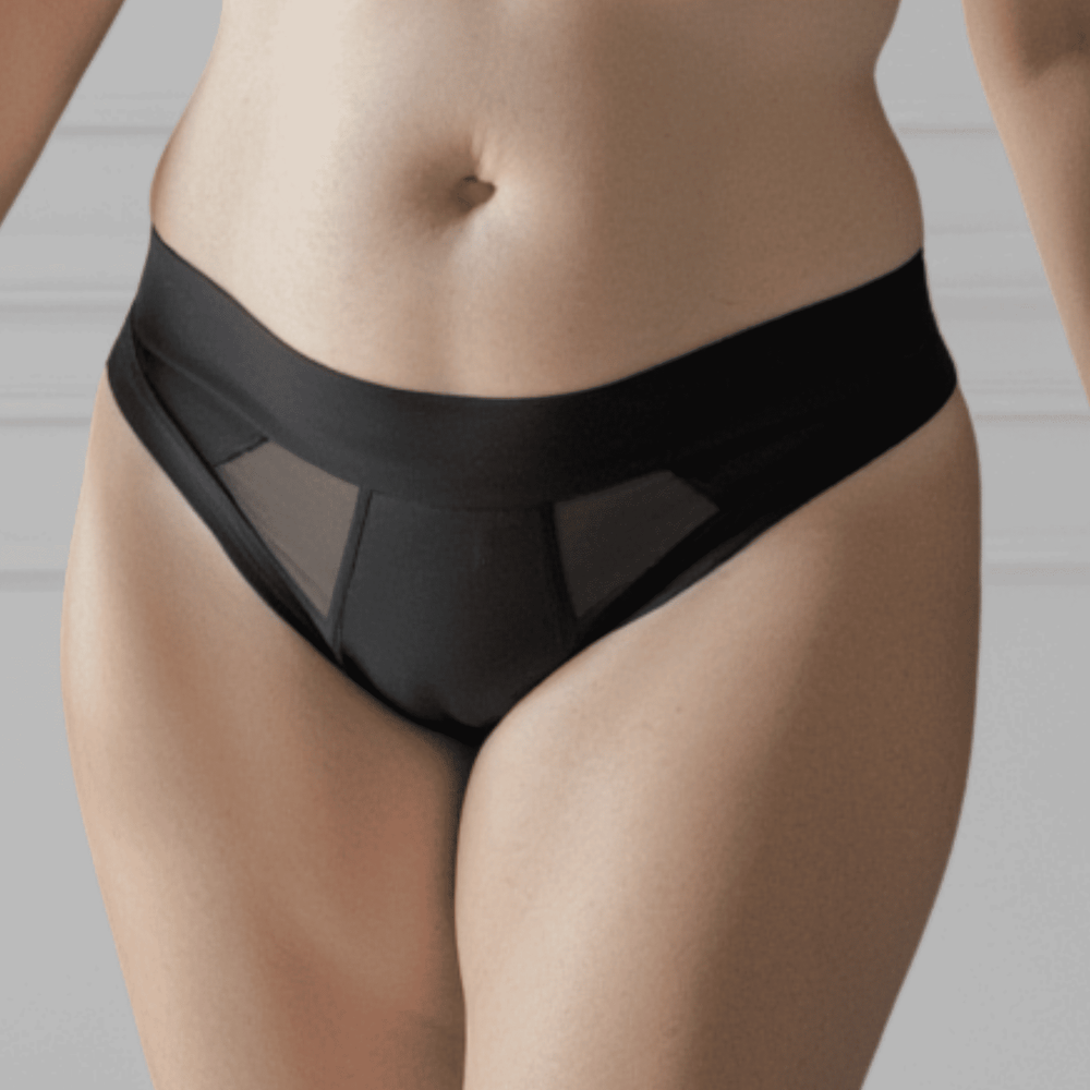 Detail of woman in her 30s wearing the size Medium Striation Thong in Obsidian black and made from OEKO TEX certified fabric