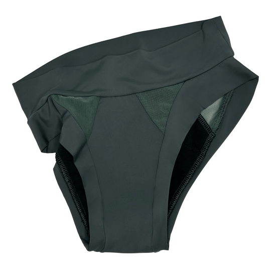 Artfully strewn flat lay image of the low-rise Swept Away brief n forest green made from OEKO TEX certified fabric