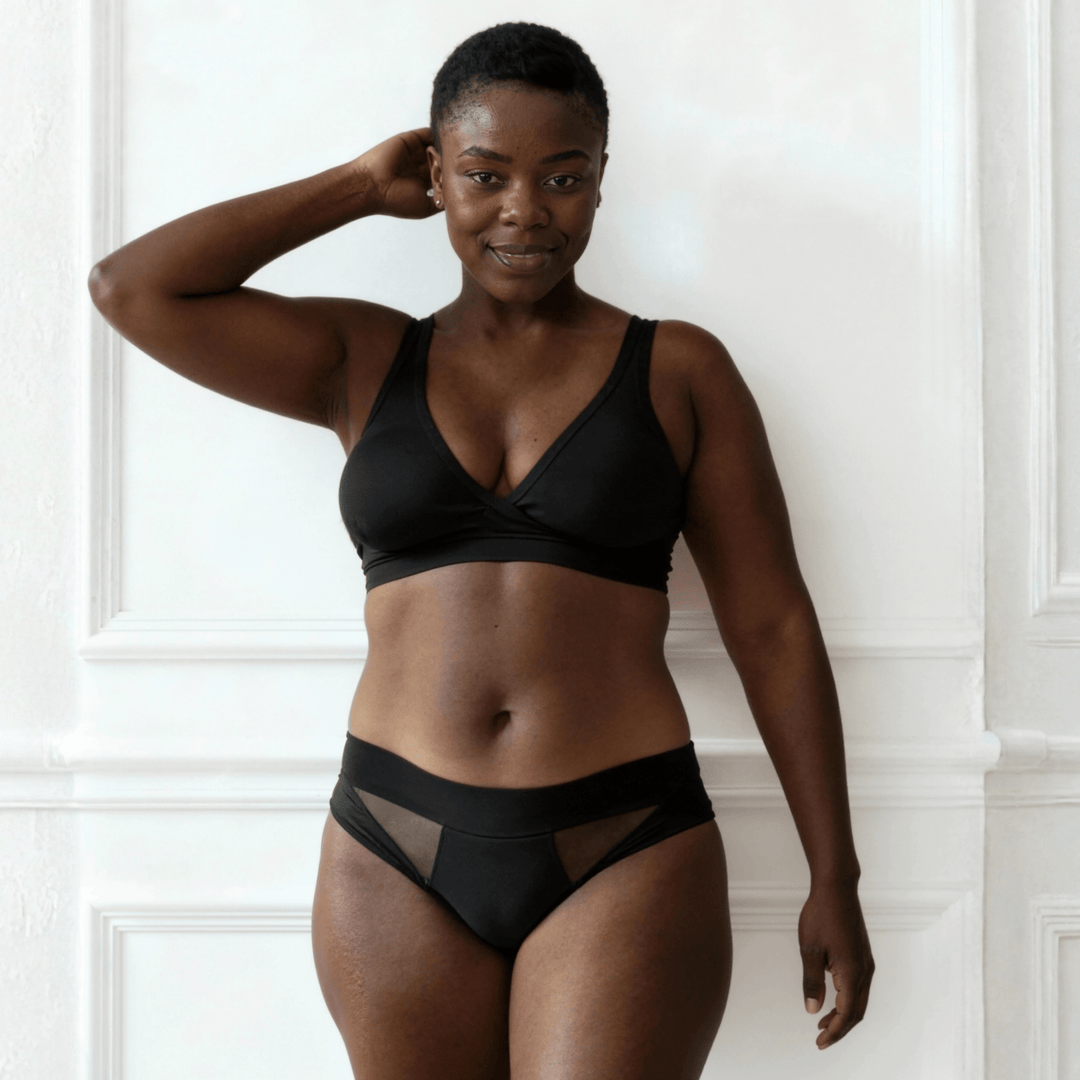 Image of woman in her 40s wearing the low-rise Swept Away brief in Obsidian Black made from OEKO TEX certified fabric