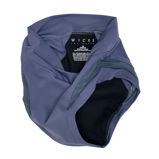 Artfully strewn flat lay image of the high-waisted Valley brief in Slate Navy made from OEKO TEX certified fabric